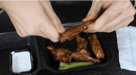 Pulling the bones out of a chicken wing makes it easier to eat. Just twist the bone and pull.
